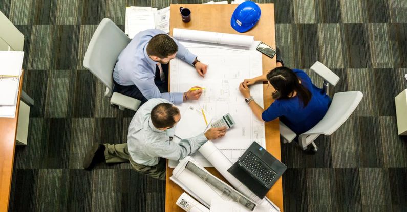 Projects - Three People Sitting Beside Table