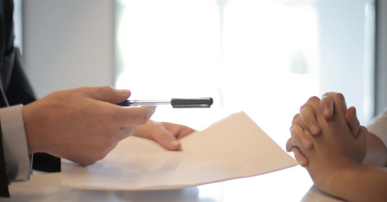 Policy - Crop businessman giving contract to woman to sign